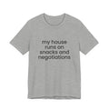 T‑Shirt — "My House Runs on Snacks and Negotiations" Funny Family Tee