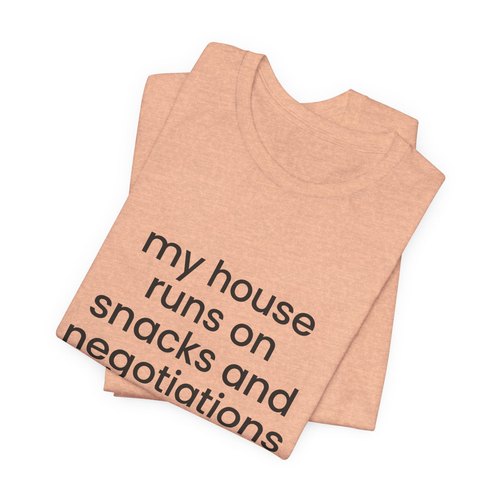 T‑Shirt — "My House Runs on Snacks and Negotiations" Funny Family Tee